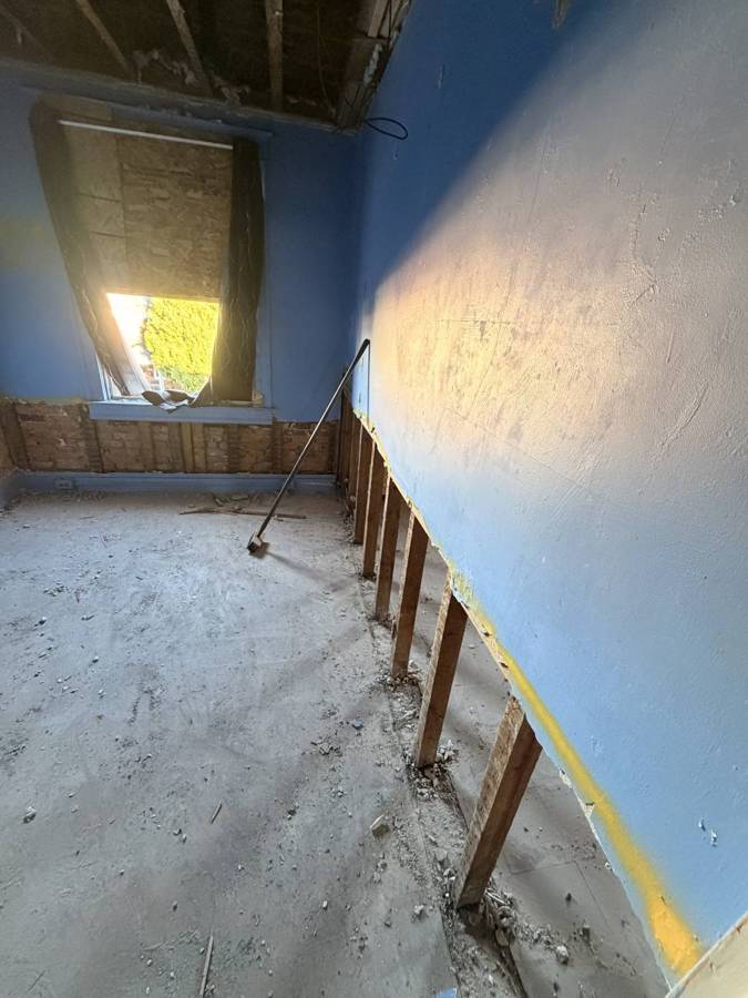 Wall cut along the bottom exposing studs